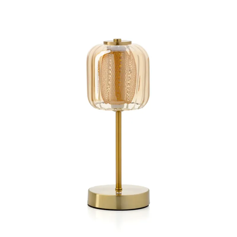 Decorative table lamp with gold base on a white background