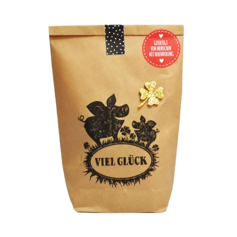 Braune Wundertüte mit Zwei aufgedruckten Glücksschweinchen mit der Schrift "Viel Glück" und einem aufgeklebten golden funkelnden Kleeblatt